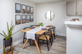 Dining nook with wood table and black chairs